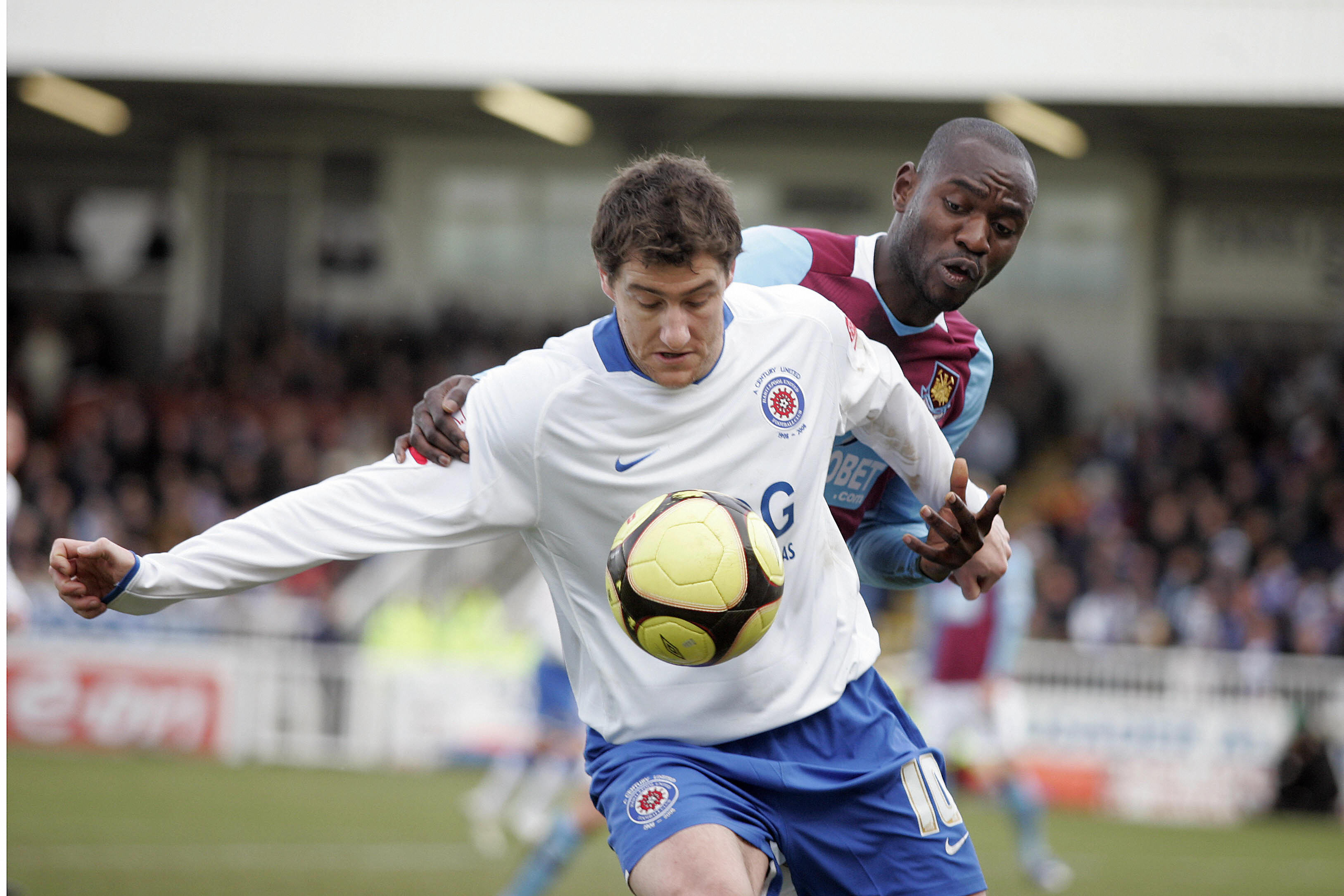 Hartlepool's Joel Porter vies with West Ham's Herita Ilunga in an FA Cup clash in January 2009.