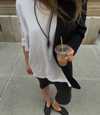 @thepouf wearing white tshirt, sheer skirt, and black mesh flats