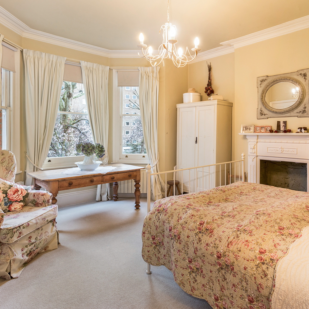 bedroom with double bed and sofa chair