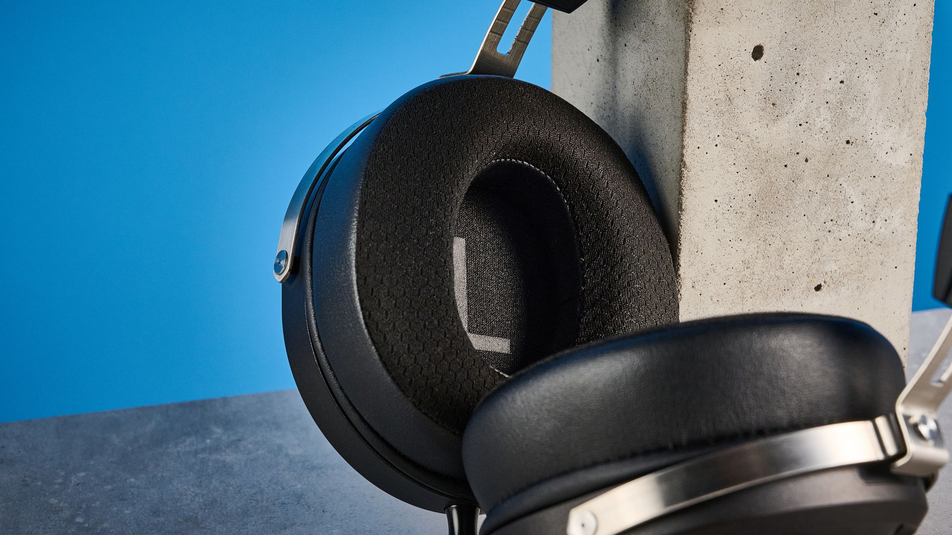 the fiio ft1 pro wired open-back headphones photographed with a blue tom's guide background