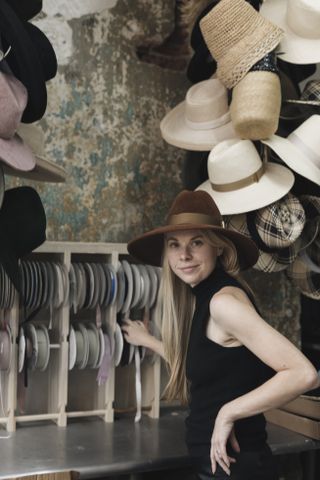 Gigi Burris in her hat-making studio choosing ribbons