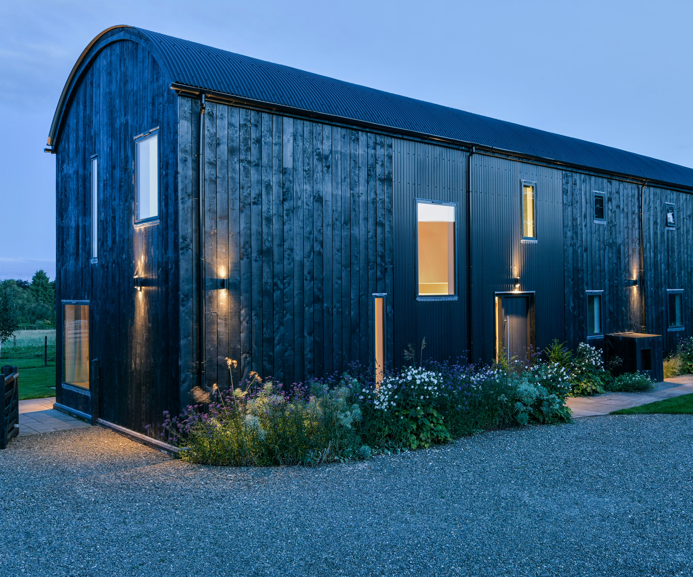 stained timber clad Dutch barn conversion