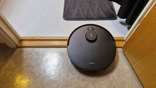 The Ecovacs Deebot T30 Omni robot vacuum crossing a threshold