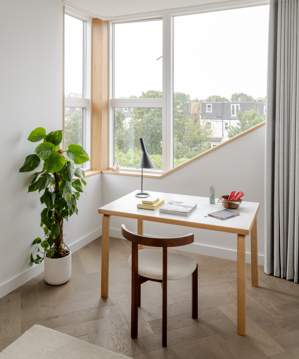 room with a table and chair overlooking window