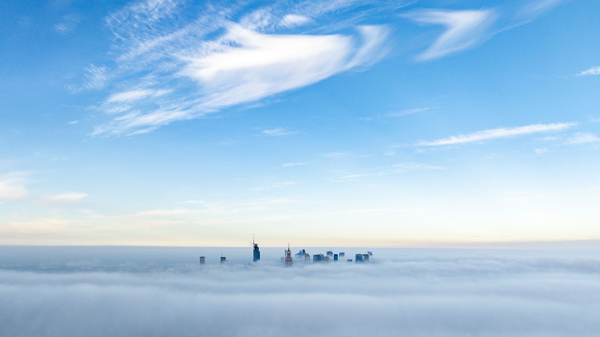 Skyscrapers pierce a blanket of autumn fog in Warsaw, Poland