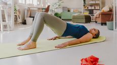 Woman performing bridge exercise at home