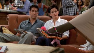 Ross and Monica looking at Phoebe's decorated shoe in Friends