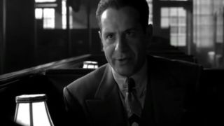 Tony Shalhoub eating ice cream in a suit and tie in The Man Who Wasn't There