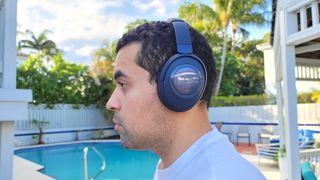 Our reviewer wearing the Cleer Audio Alpha to test comfort and fit