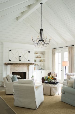 farmhouse style living room with white curtains and vaulted ceiling