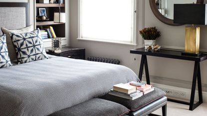 bedroom with bed, console tbale and shelving