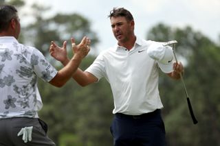 Koepka shakes hands with Woodland after the second round of The Masters