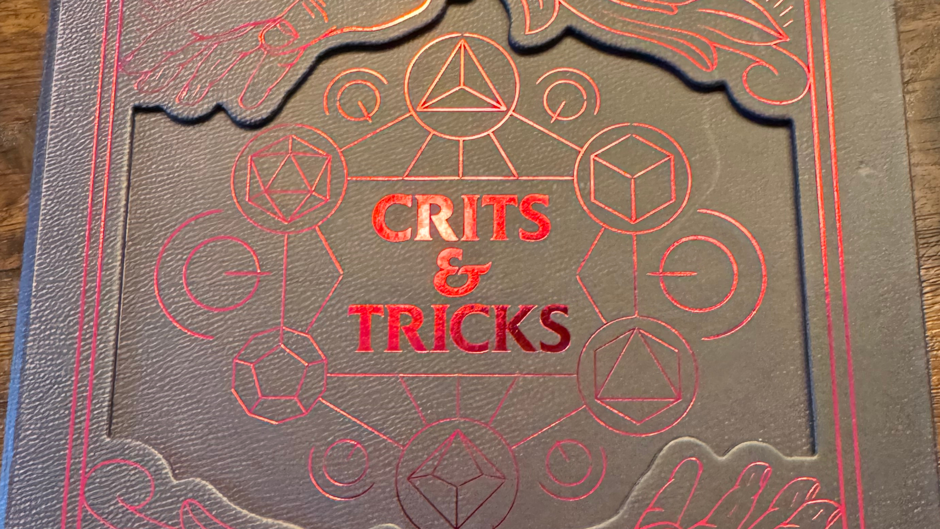 Crits &amp; Tricks box with the logo in red, surrounded by dice symbols