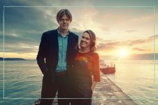 a still of Kris Marshall and Sally Bretton posing on a pier in Beyond Paradise