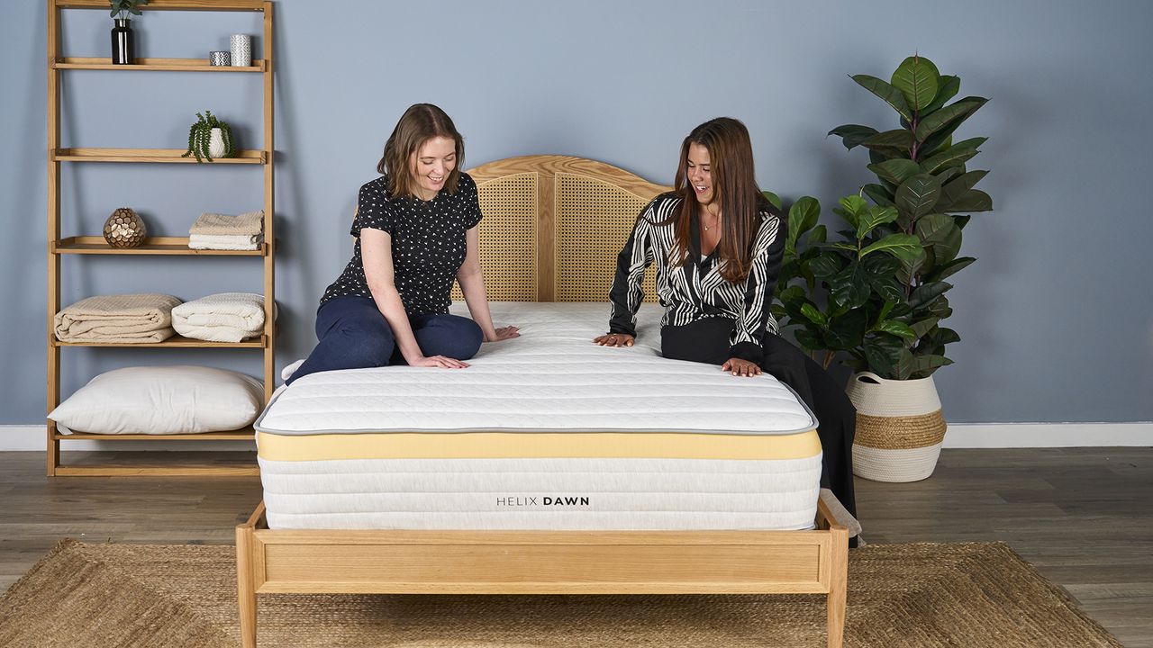 Tester Ruth Jones and mattress writer Eve Davies sit on the Helix Dawn Mattress in our Sleep Lab
