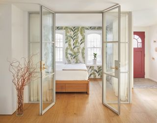 Guest room with nature inspired wallpaper at Boerum Hill townhouse