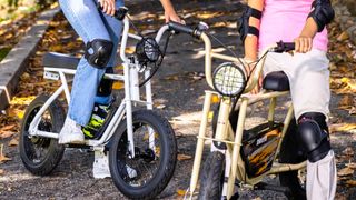 Two children riding Droyd Blipper bikes outside