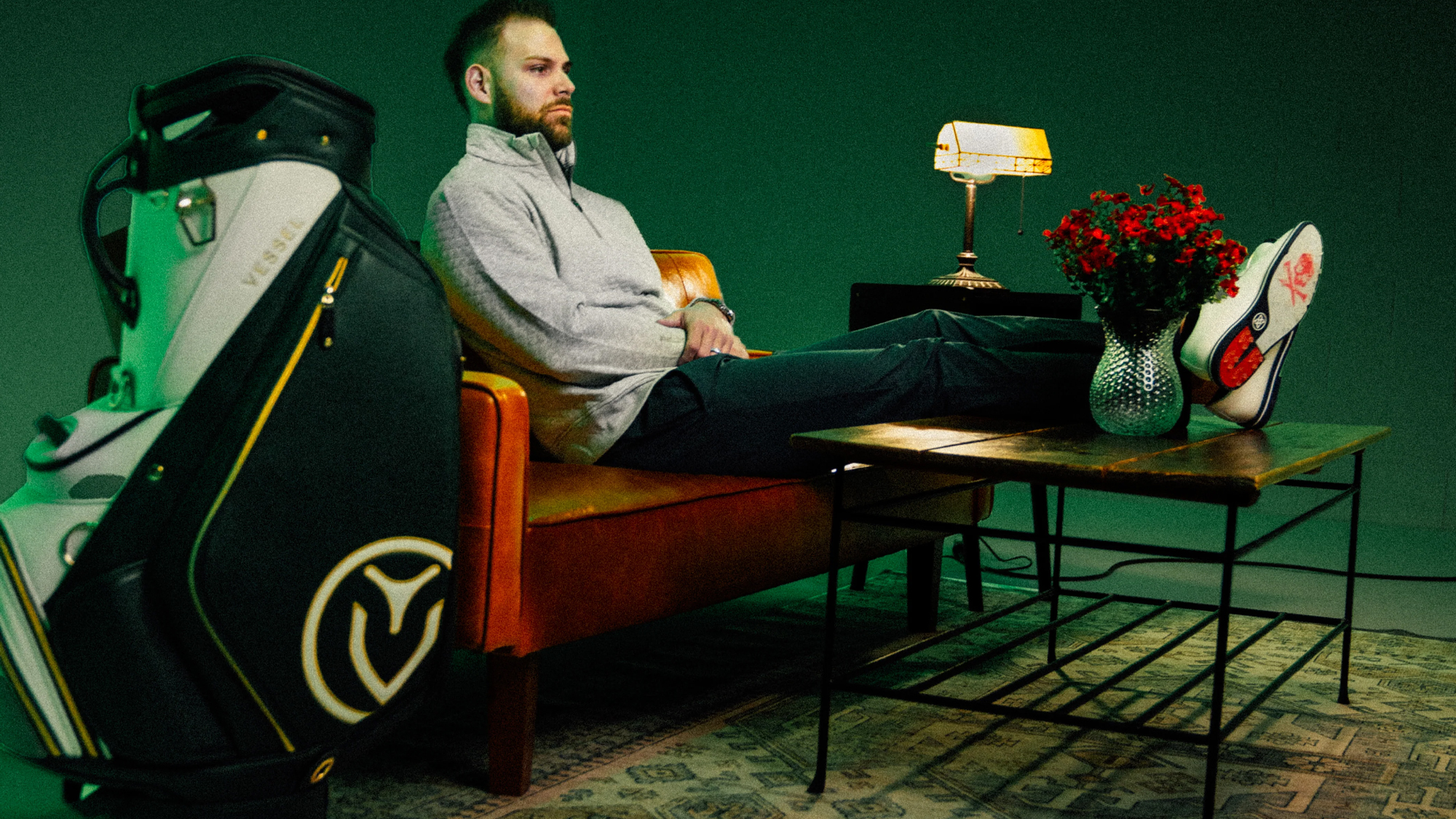 Vessel golf bag and a person sitting on a couch