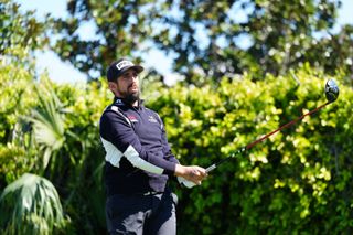 Matthieu Pavon watches his tee shot with a driver