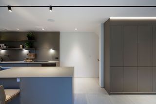 A neutral coloured kitchen inside a triangle-shaped home