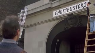 The exterior of the Ghostbusters headquarters with the sign going up