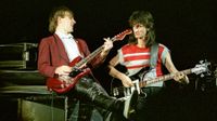 Alex Lifeson and Geddy Lee of Canadian band Rush perform on stage on the 'Signals' tour at Wembley Arena on May 20th, 1983 in London, England. Lifeson is playing his red Hentor Sportscaster