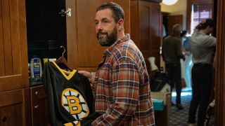 Adam Sandler smiles wistfully as he holds his old jersey in Happy Gilmore 2.