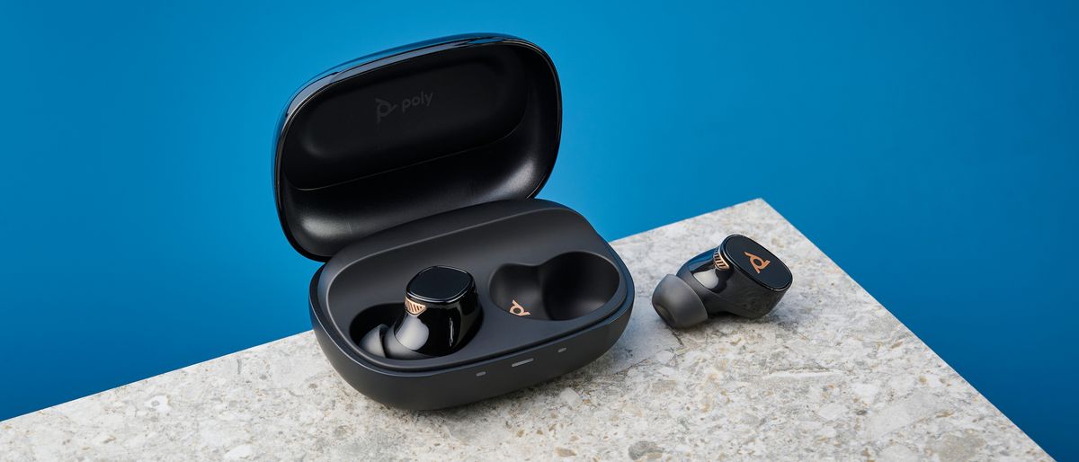 A pair of black and gold HP Poly Voyager Free 20 wireless earbuds