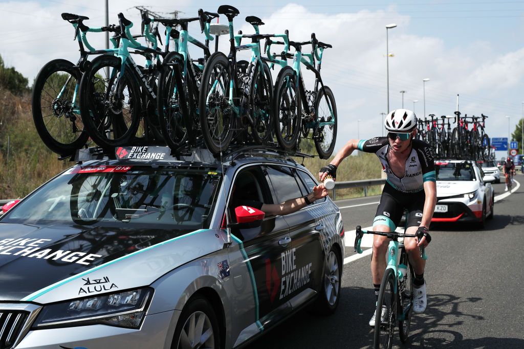 ALTO DE LA MONTAA DE CULLERA SPAIN AUGUST 19 Lucas Hamilton of Australia and Team BikeExchange picks bottles from Team car during the 76th Tour of Spain 2021 Stage 6 a 1583km stage from Requena to Alto de la Montaa de Cullera 184m lavuelta LaVuelta21 on August 19 2021 in Alto de la Montaa de Cullera Spain Photo by Gonzalo Arroyo MorenoGetty Images