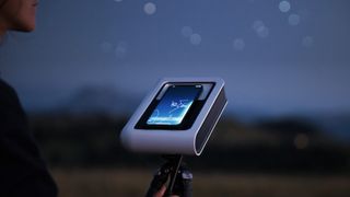Vaonis Hestia smart telescope mounted to tripod and pointed up to the night sky