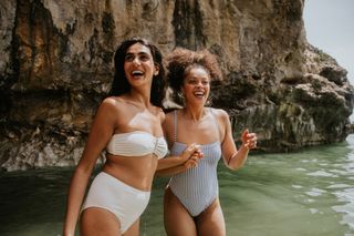 Two friends enjoying time at a beach while on holiday.