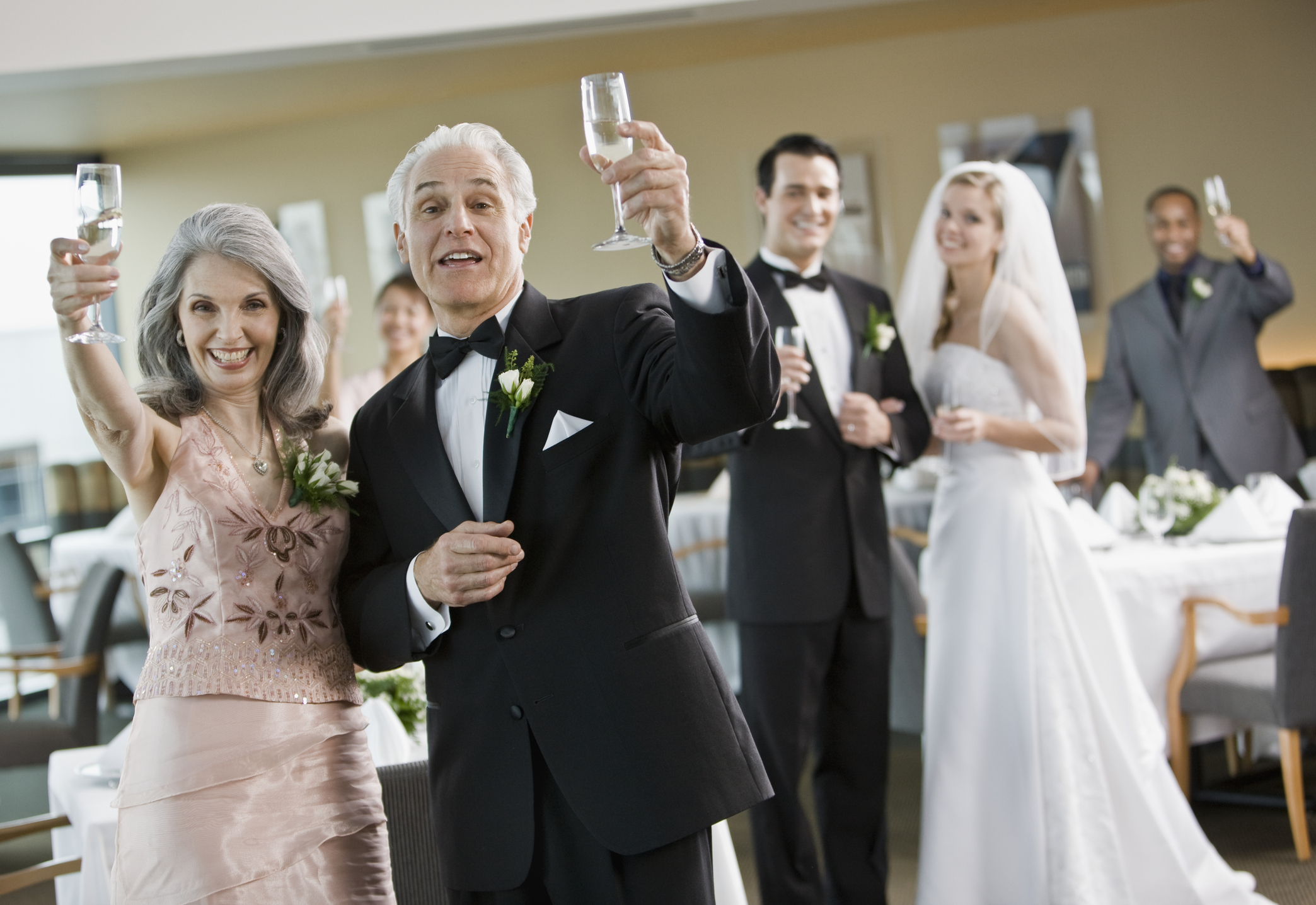 Group portrait during toast at wedding party