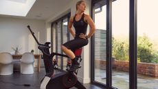 Women sat on the Wattbike Atom bike takes a break