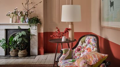 living room colour schemes, grey living room with tongue and groove walls, cream sofa, rattan side table, baskets, artwork, plants, textured cushions, rug, vases 