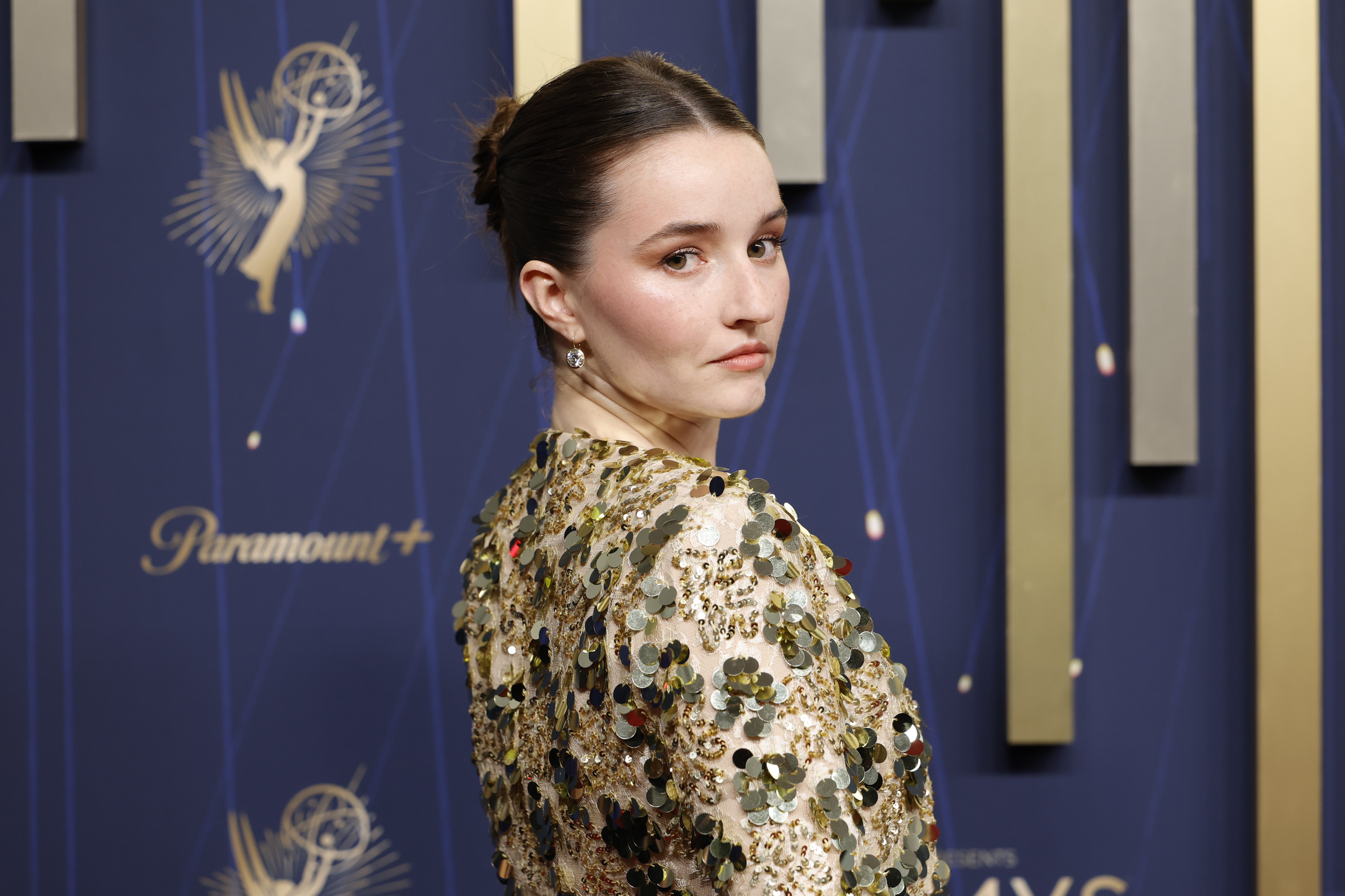 Kaitlyn Dever in a sequin jacket with rosy makeup
