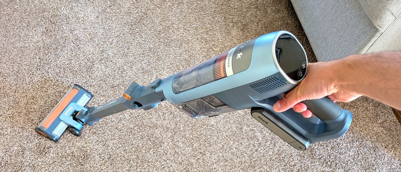 Person cleaning carpet with Shark PowerDetect Speed vacuum cleaner