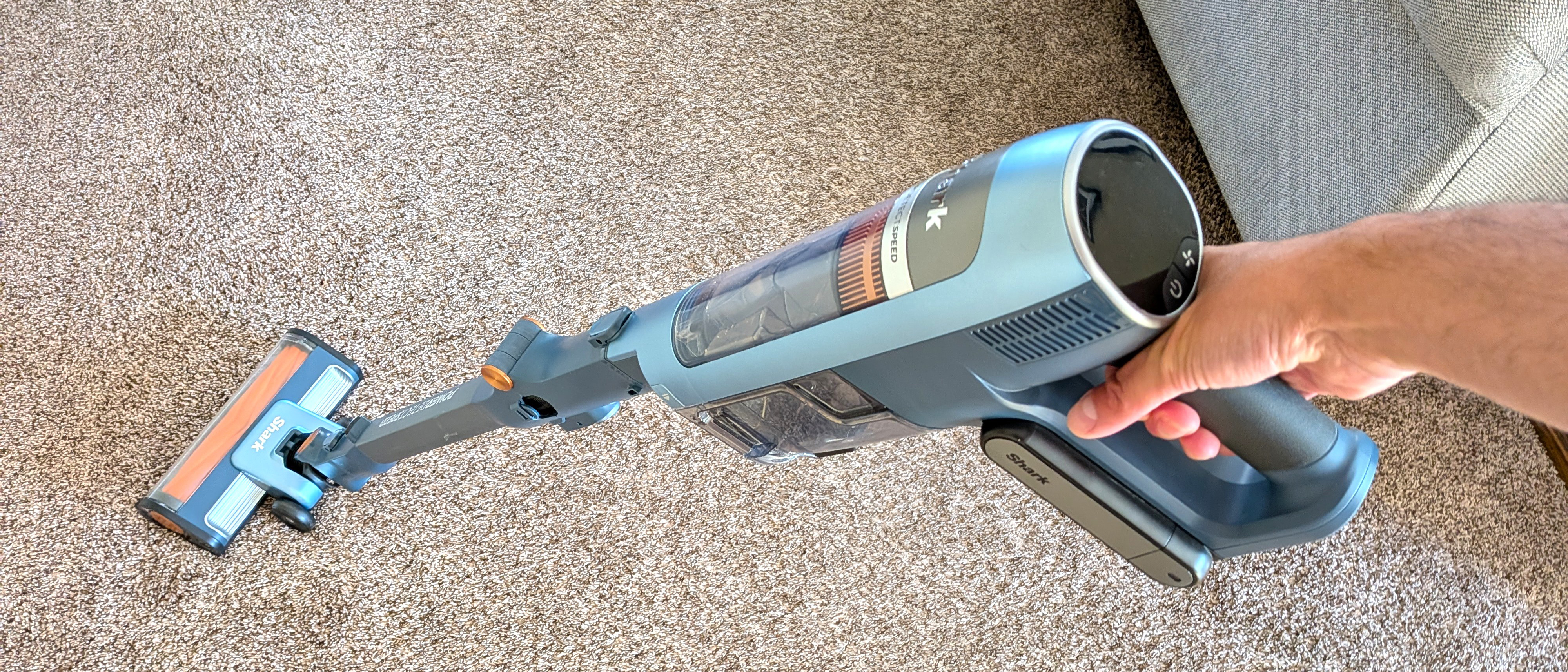 Person cleaning carpet with Shark PowerDetect Speed vacuum cleaner