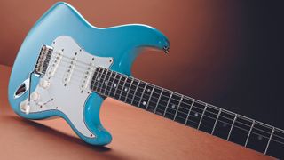 Blue Eric Johnson Stratocaster balanced on its side