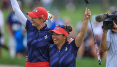 Nelly Korda and Megan Khang hold their putters in the air