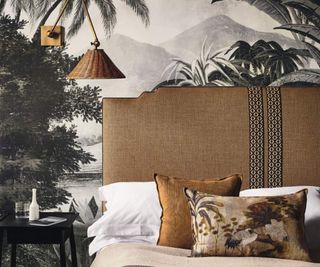 A bed against botanical wallpaper.