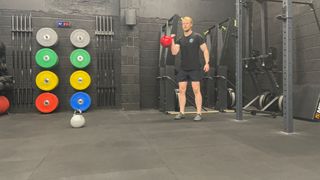 TechRadar fitness writer Harry Bullmore performing a kettlebell curl