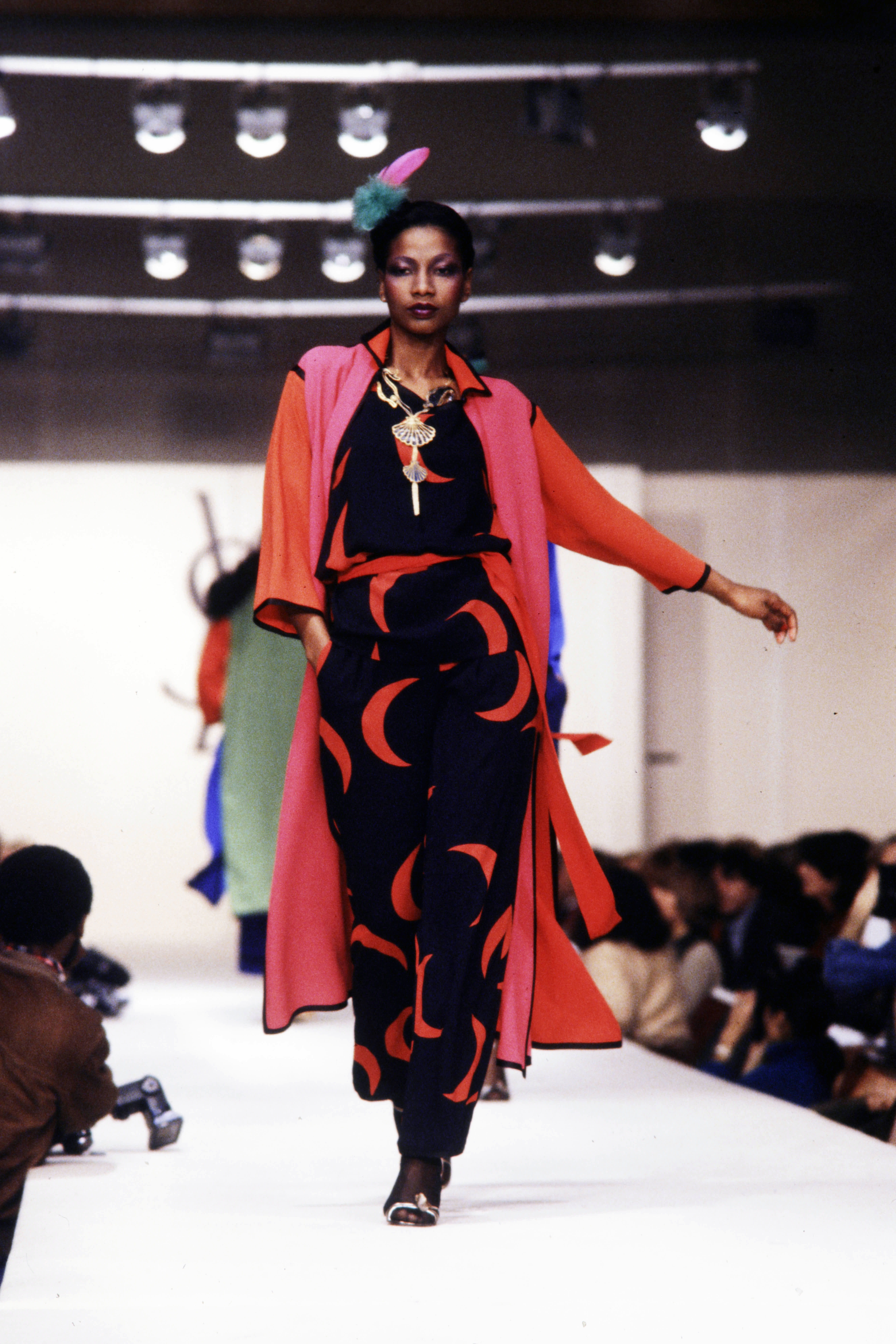 A model wears a celestial black-and-red gown on the YSL Spring 1979 runway.