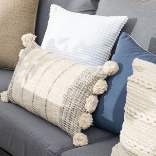 Grey and white cushions on grey sofa