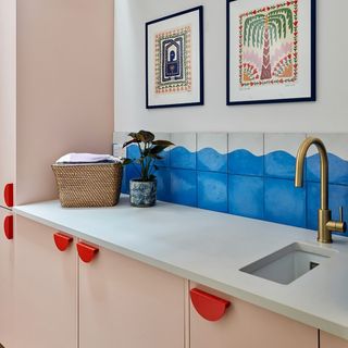Husk pink utility room with red half moon handles