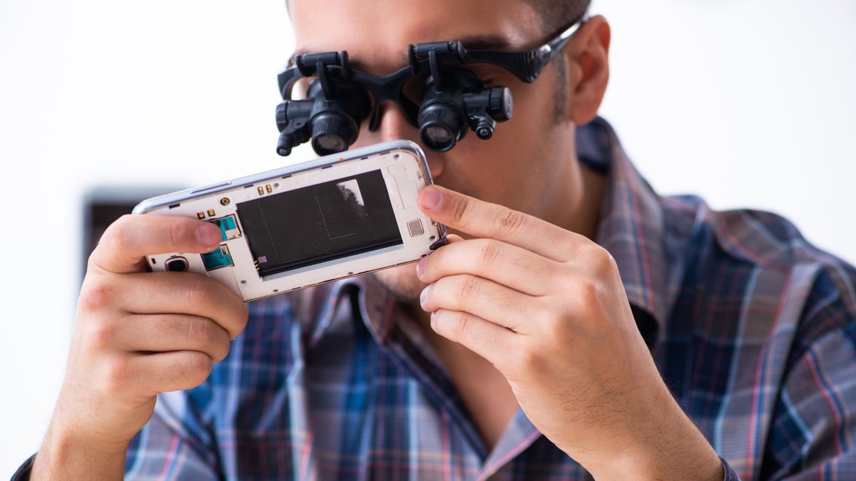 Refurbished tech; a photo of a man repairing a refurbished smartphone