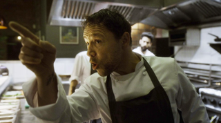 Boiling Point's head chef (Stephen Graham) points his finger angrily in a busy kitchen.