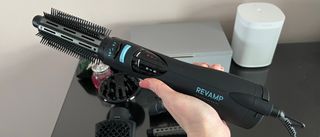 The Revamp Progloss Airstyle 6-in-1Air Styler DR-1250 being held ready to use