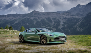 An image of the Aston Martin DB12 in a scenic landscape
