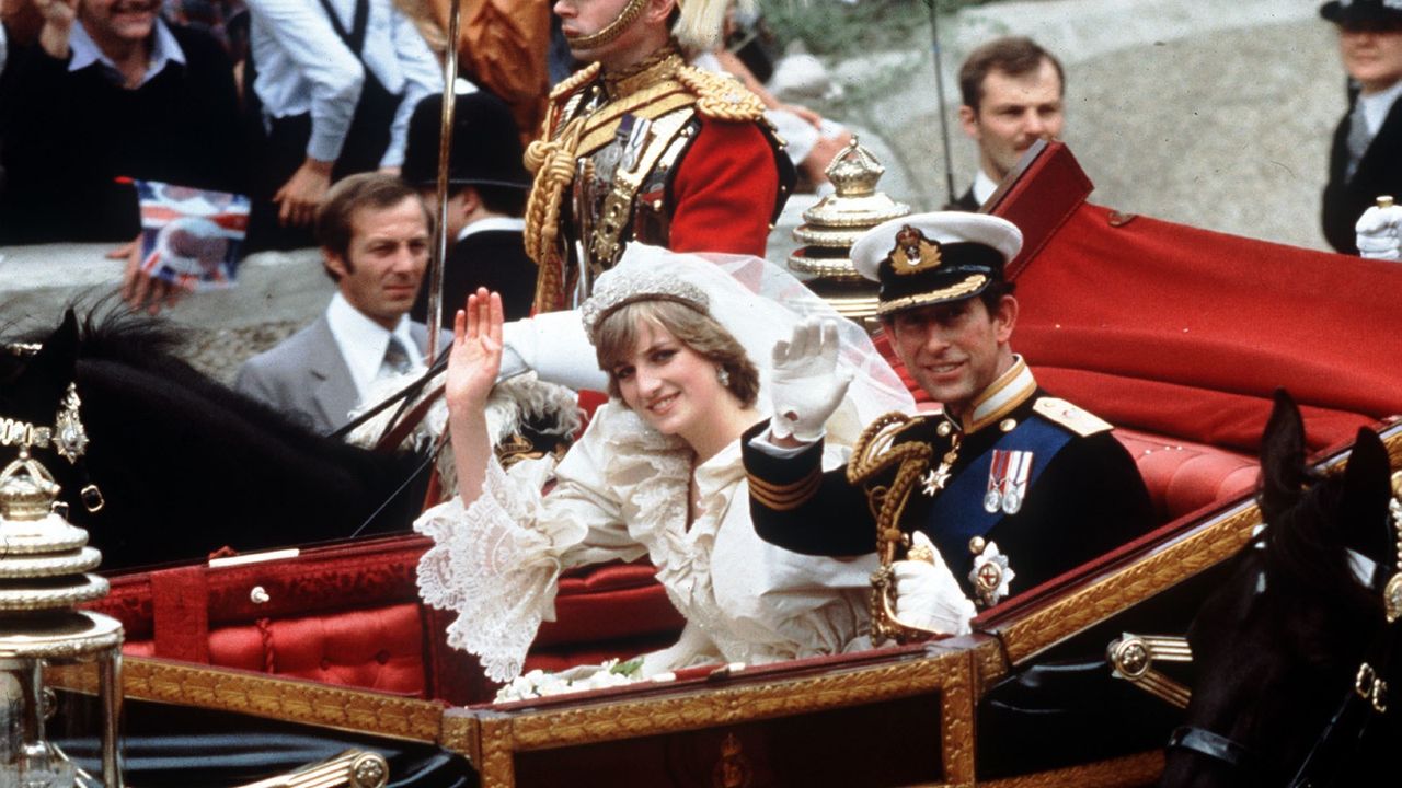 Princess Diana&#039;s wedding: The Prince and Princess of Wales smile and wave to the crowds during their carriage procession to Buckingham Palace after their wedding at St.Paul&#039;s Cathedral.