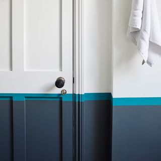 White bathroom with half blue painted wall